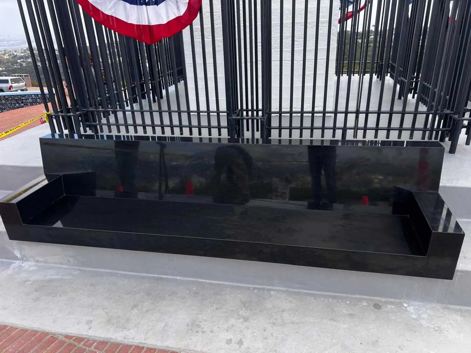 Elegant black granite memorial bench with a polished finish.