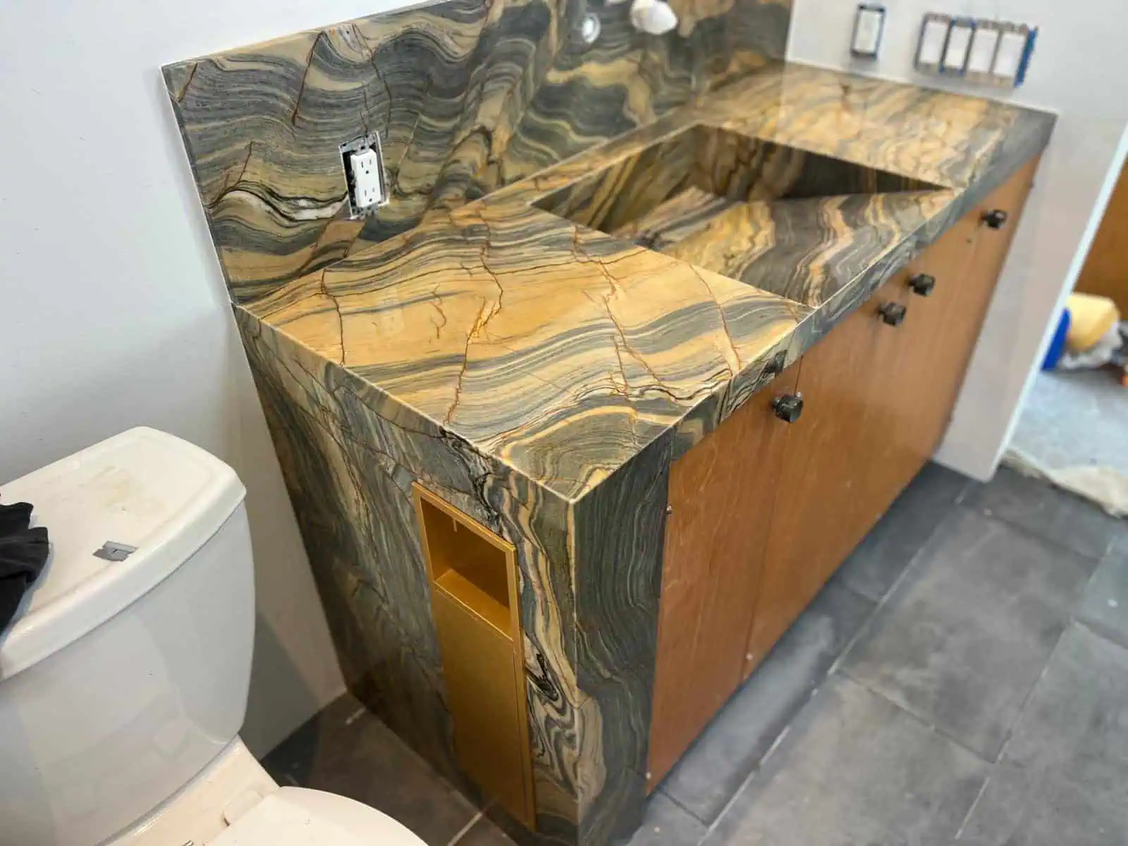 Luxury stone slab bathroom vanity with integrated sink and wooden cabinet.
