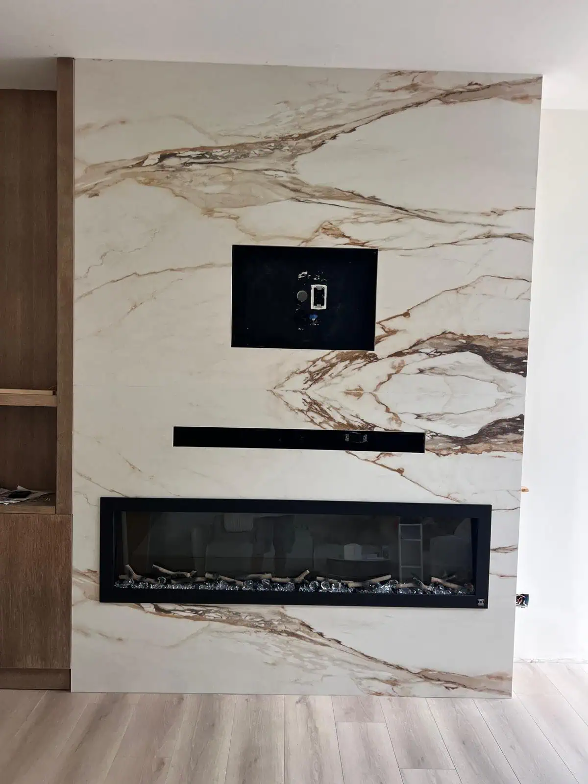 Modern fireplace with marble surround and built-in TV space.